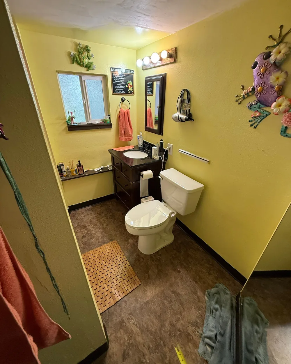 Dated shower with yellow walls before remodel in Des Moines