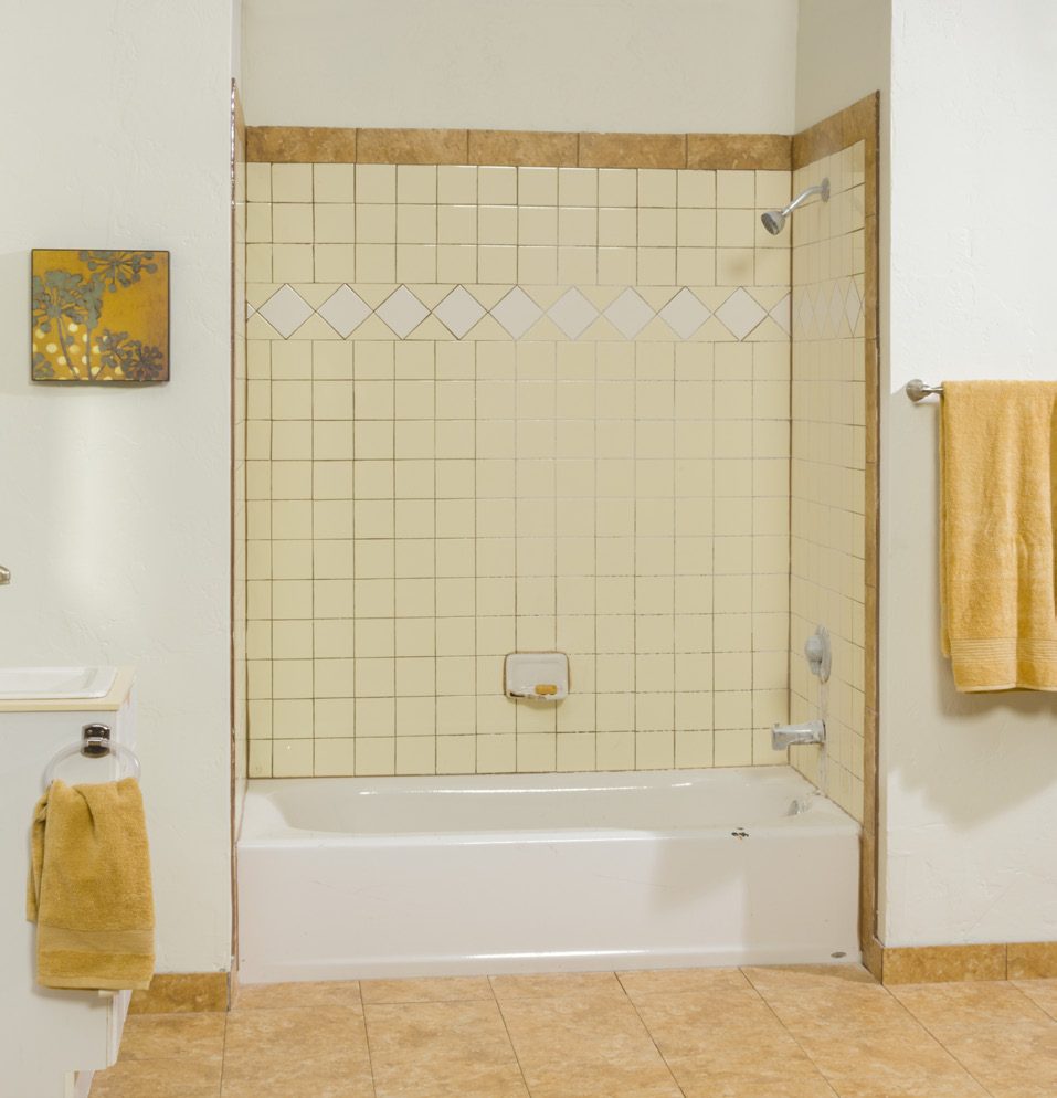 Low-threshold tub-to-shower conversion with tile surround